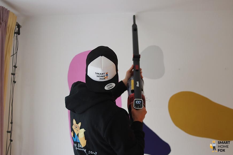 Shark Anti Hair Wrap is seen cleaning the edges of a blanket.